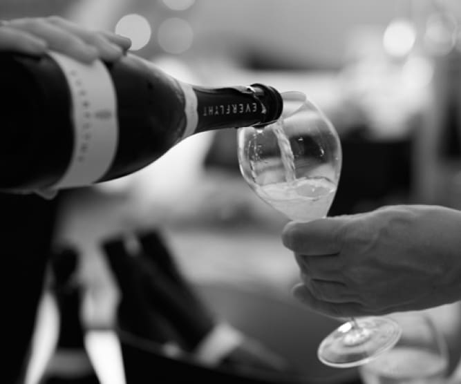bottle of everyflyht wine being poured into flute