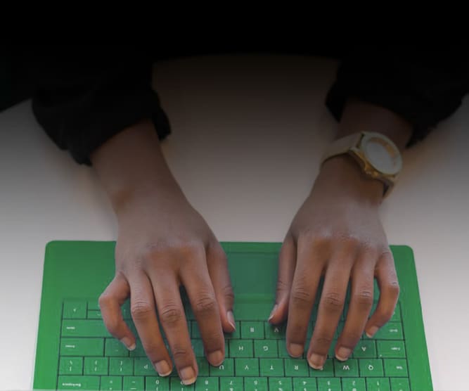 photo of person typing on green keyboard