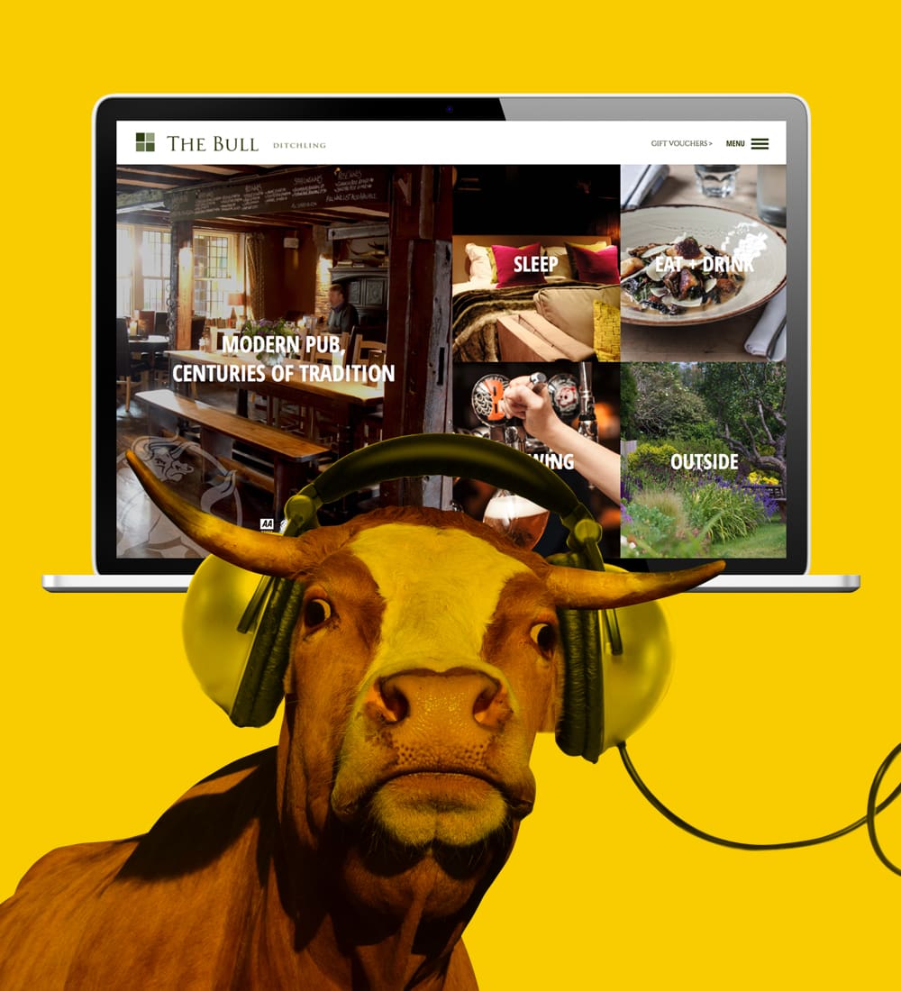 website design for the bull pub in ditchling shown on a computer screen, alongside bull wearing headphones graphic